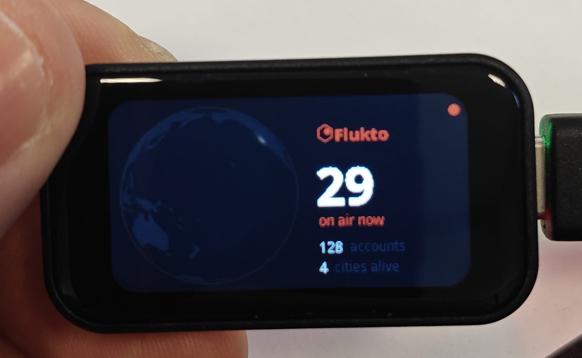 The Flukto Globe: a small display on a desk with the turning planet and the number of people on air.